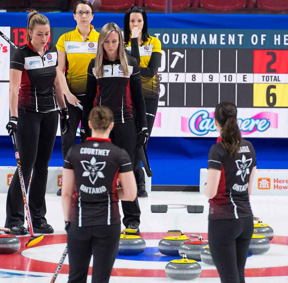 Team Manitoba skip, Kerri Einarson and third, Val Sweeting look on as Team Ontario skip, Rachel Homan and third, Emma Miskew line up a shot. (Jonathan Hayward / The Canadian Press)