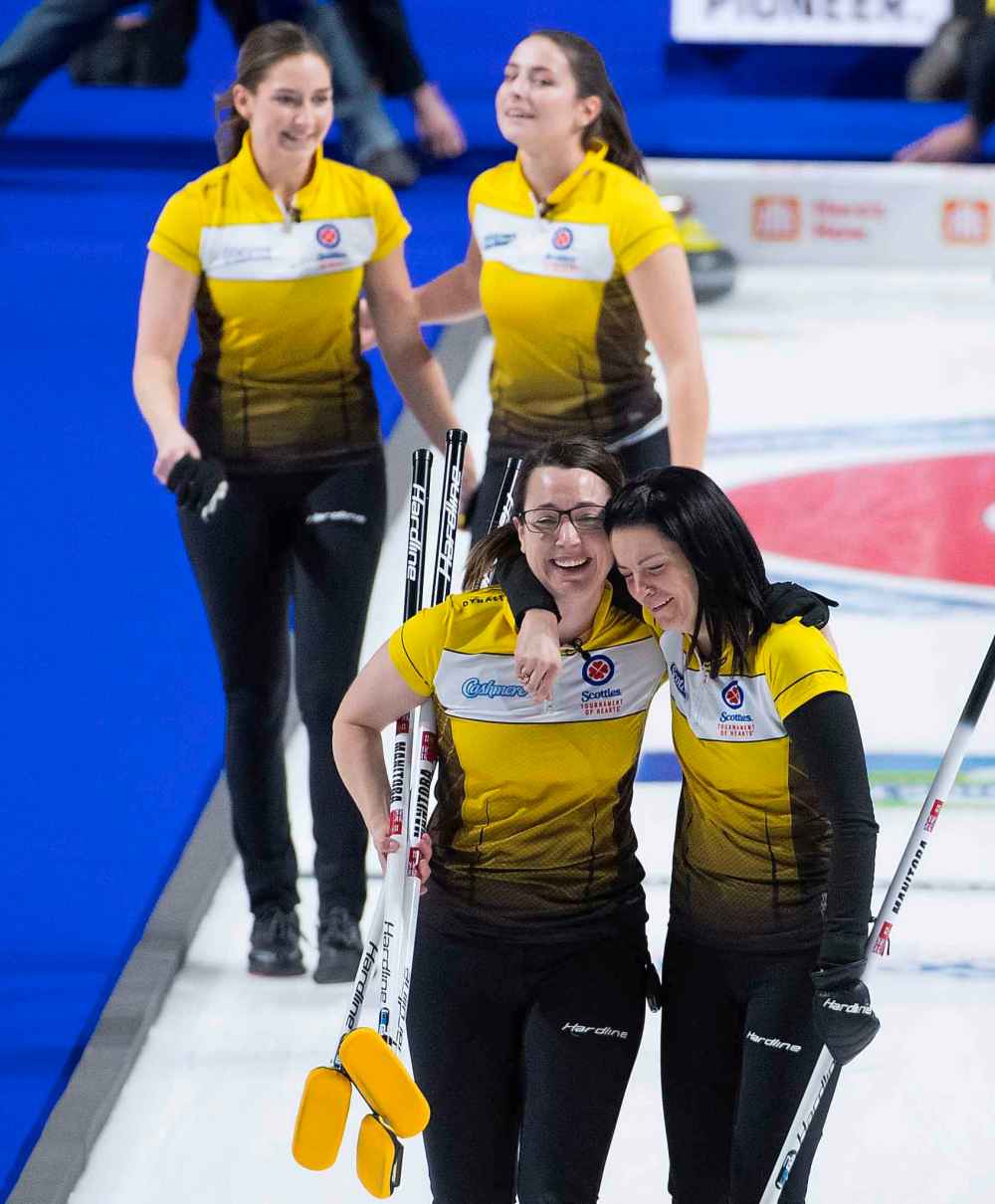 Team Manitoba skip Kerri Einarson, front right, third Val Sweeting, second, Shannon Birchard, back right, and lead, Briane Meilleur celebrate after defeating Team Ontario. (Jonathan Hayward / The Canadian Press)