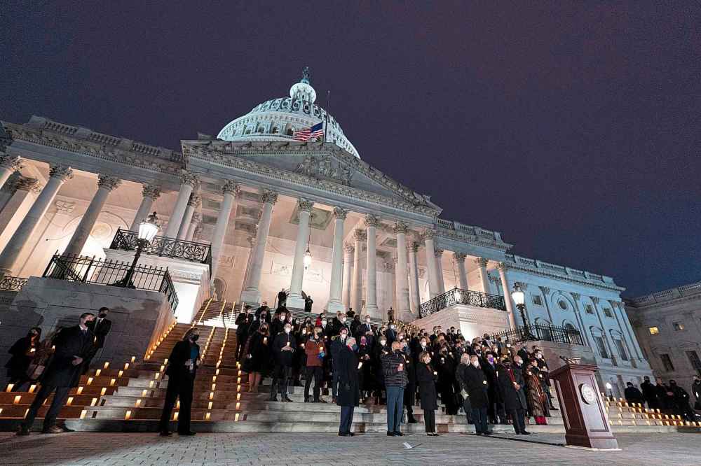 House Speaker Nancy Pelosi of Calif., leads members of the House and the Senate observe a moment of silence during a vigil to commemorating the anniversary of the deadly attack on the U.S. Capitol, Thursday, Jan. 6, 2022, in Washington. (AP Photo/Manuel Balce Ceneta)