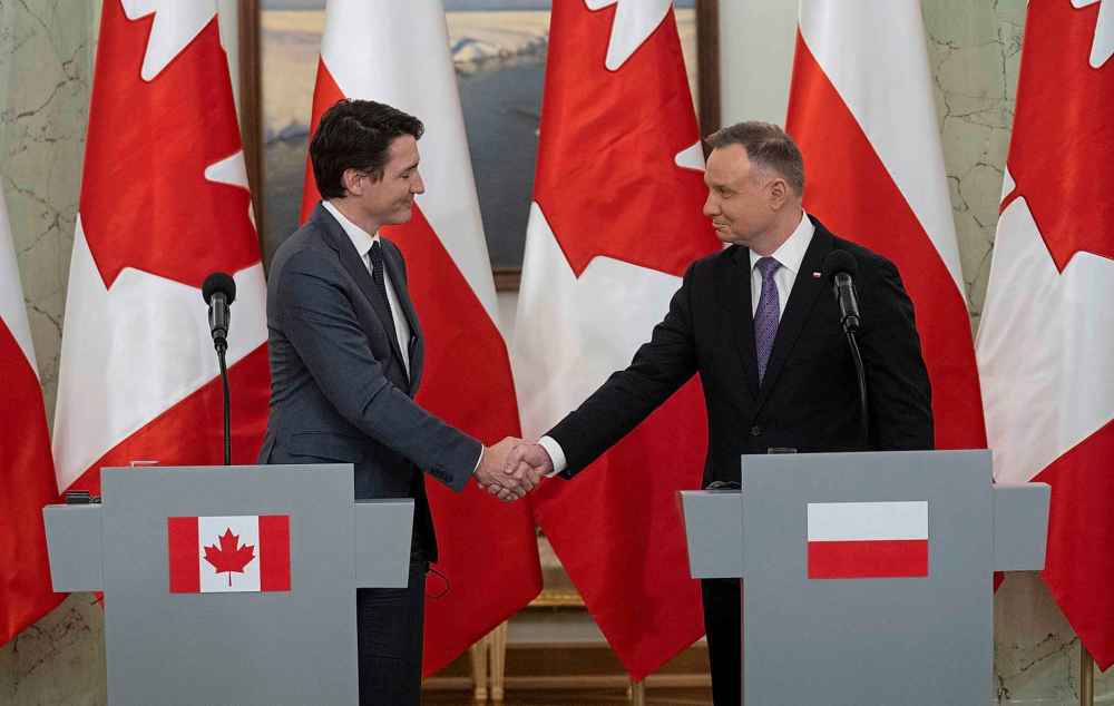 Canadian Prime Minister Justin Trudeau shakes hands with Polish President Andrzej Duda at the end of a joint news conference in Warsaw, Poland, Thursday, March 10, 2022.  THE CANADIAN PRESS/Adrian Wyld