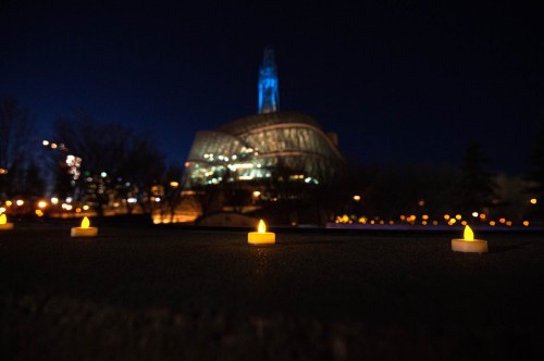 MIKE SUDOMA / WINNIPEG FREE PRESS

Tea light candles line the edge of the bowl at the Plaza at the Forks as the Canadian Museum for Human Rights looms in the background. Hundreds of the candles can be found around the Winnipeg sign beside Scotia Bank Stage to commemorate the lives lost during the first year of the Covid 19 pandemic. The top of the Canada Museum for Human Rights’ tower will be lit up blue in tribute to the health care workers who have been on the frontlines of the pandemic. The memorial will be on display form March 11-14.

March 10, 2021