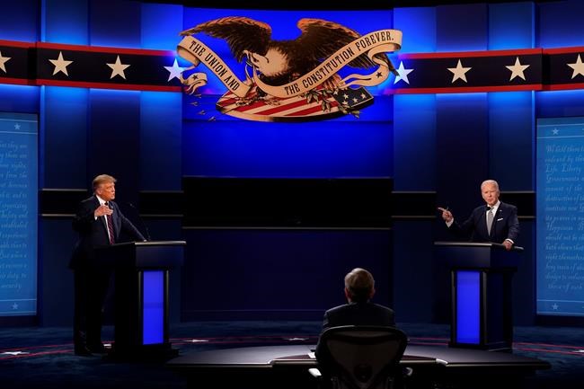 President Donald Trump, left, and Democratic presidential candidate former Vice President Joe Biden, right, with moderator Chris Wallace, center, of Fox News during the first presidential debate Tuesday, Sept. 29, 2020, at Case Western University and Cleveland Clinic, in Cleveland, Ohio. (AP Photo/Patrick Semansky)