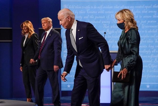 In this Sept. 29, 2020, file photo, from l-r., first lady Melania Trump, President Donald Trump, Democratic presidential candidate former Vice President Joe Biden and Jill Biden during the first presidential debate at Case Western University and Cleveland Clinic, in Cleveland, Ohio. President Trump and first lady Melania Trump have tested positive for the coronavirus, the president tweeted early Friday. (AP Photo/Julio Cortez, File)