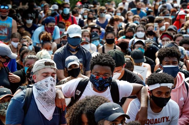 Demonstrators protest Thursday, June 4, 2020, at the Martin Luther King Jr. Memorial in Washington, over the death of George Floyd, a black man who was in police custody in Minneapolis. Floyd died after being restrained by Minneapolis police officers. (AP Photo/Alex Brandon)