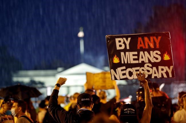 Demonstrators protest Thursday, June 4, 2020, near the White House in Washington, over the death of George Floyd, a black man who was in police custody in Minneapolis. Floyd died after being restrained by Minneapolis police officers. (AP Photo/Alex Brandon)