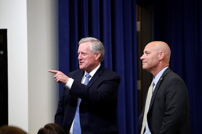 White House chief of staff Mark Meadows, left, and Vice President Mike Pence's chief of staff Marc Short speak before an event with President Donald Trump to sign executive orders on lowering drug prices, in the South Court Auditorium in the White House complex, Friday, July 24, 2020, in Washington. (AP Photo/Alex Brandon)