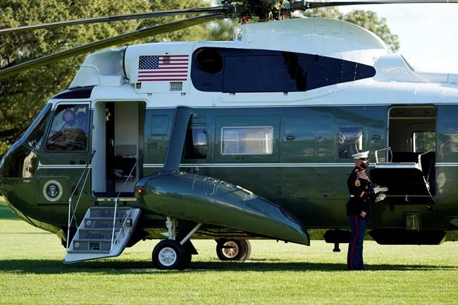 A pilot of Marine One wears a face mask as President Donald Trump prepares to leave the White House to go to Walter Reed National Military Medical Center after he tested positive for COVID-19, Friday, Oct. 2, 2020, in Washington. (AP Photo/Alex Brandon)