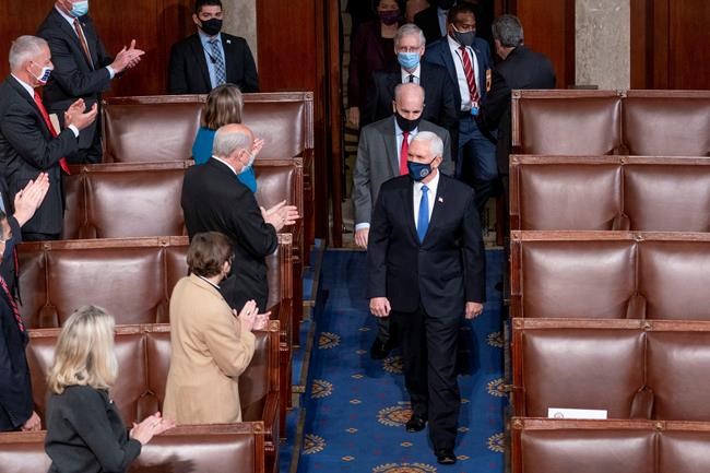 Vice President Mike Pence and Senate Majority Leader Mitch McConnell of Ky., top center, arrive along with other senators for a joint session of the House and Senate convenes to confirm the electoral votes cast in November's election, at the Capitol in Washington, Wednesday, Jan. 6, 2021. (AP Photo/Andrew Harnik)