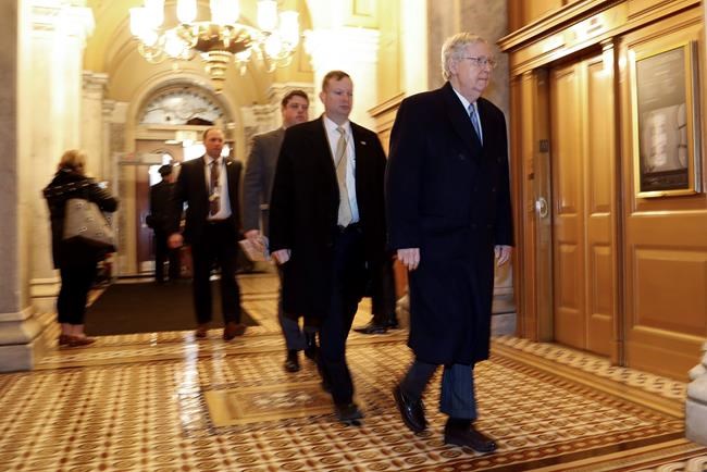 Senate Majority Leader Mitch McConnell of Ky., right, arrives at the Capitol in Washington during the impeachment trial of President Donald Trump on charges of abuse of power and obstruction of Congress, Friday, Jan. 24, 2020. (AP Photo/Julio Cortez)