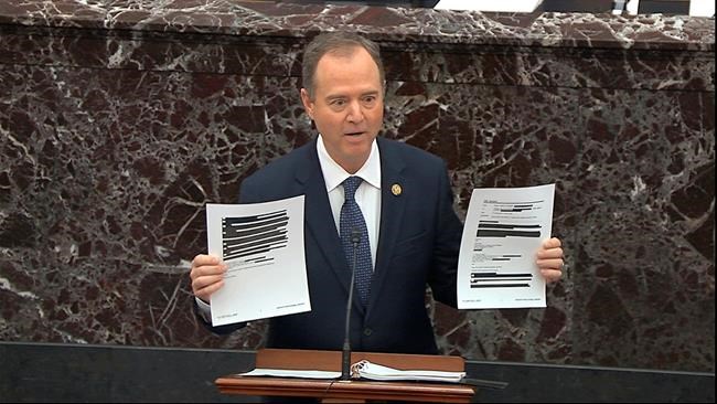 In this image from video, House impeachment manager Rep. Adam Schiff, D-Calif., holds redacted documents as he speaks during the impeachment trial against President Donald Trump in the Senate at the U.S. Capitol in Washington, Wednesday, Jan. 22, 2020. (Senate Television via AP)