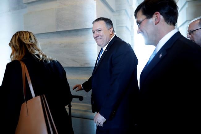 Secretary of State Mike Pompeo, center, walks with Defense Secretary Mark Esper, right, as they leave the Capitol after briefing Senators on the details of the threat that prompted the U.S. targeted killing of Iranian Gen. Qassem Soleiman in Iraq, Wednesday, Jan. 8, 2020 on Capitol Hill in Washington. (AP Photo/ Jacquelyn Martin)