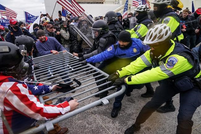 Trump supporters try to break through a police barrier, Wednesday, Jan. 6, 2021, at the Capitol in Washington. As Congress prepares to affirm President-elect Joe Biden's victory, thousands of people have gathered to show their support for President Donald Trump and his claims of election fraud.(AP Photo/John Minchillo)