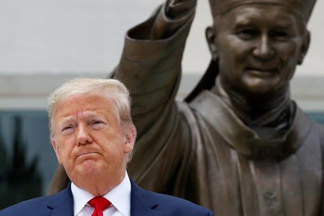 President Donald Trump visits Saint John Paul II National Shrine with first lady Melania Trump, Tuesday, June 2, 2020, in Washington. (AP Photo/Patrick Semansky)