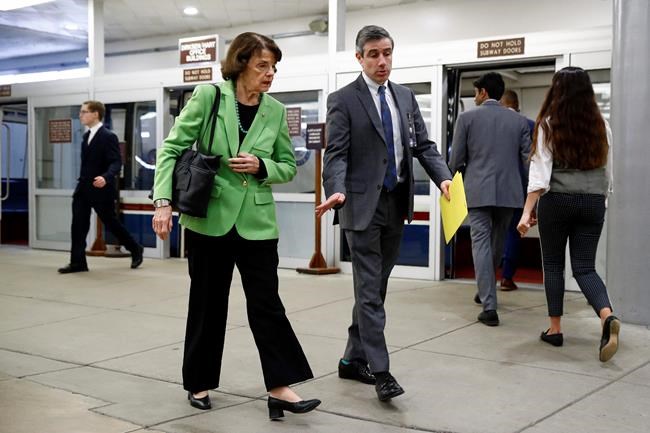 Sen. Dianne Feinstein, D-Calif., left, walks on Capitol Hill in Washington during the impeachment trial of President Donald Trump on charges of abuse of power and obstruction of Congress, Wednesday, Feb. 5, 2020. (AP Photo/Patrick Semansky)