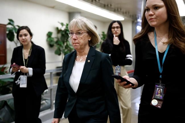 Sen. Patty Murray, D-Wash., center, walks on Capitol Hill in Washington during the impeachment trial of President Donald Trump on charges of abuse of power and obstruction of Congress, Wednesday, Feb. 5, 2020. (AP Photo/Patrick Semansky)