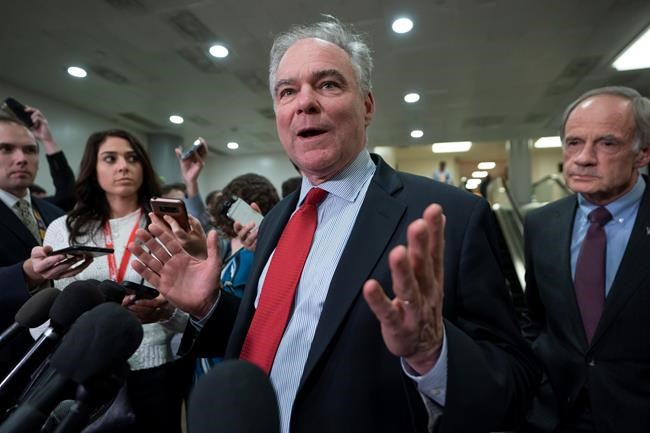 Sen. Tim Kaine, D-Va., a member of the Senate Armed Services Committee and the Foreign Relations Committee, joined at right by Sen.Tom Carper, D-Del., responds to reporters following a briefing by Secretary of State Mike Pompeo, Defense Secretary Mark Esper, and other national security officials on the details of the threat that prompted the U.S. to kill Iranian Gen. Qassem Soleimani in Iraq, Wednesday, Jan. 8, 2020 on Capitol Hill in Washington. (AP Photo/J. Scott Applewhite)