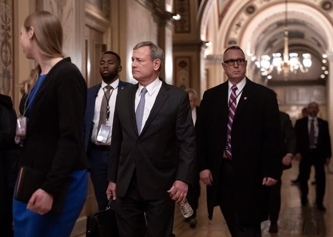 Chief Justice John Roberts departs the U.S. Capitol Wednesday, Jan. 22, 2020, following arguments in the impeachment trial of President Donald Trump on charges of abuse of power and obstruction of Congress, in Washington. (AP Photo/J. Scott Applewhite)