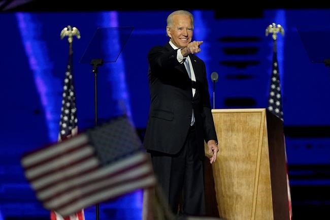 President-elect Joe Biden gesturing on stage after speaking, Saturday, Nov. 7, 2020, in Wilmington, Del. (AP Photo/Andrew Harnik, Pool)