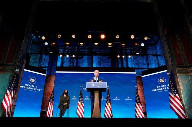 President-elect Joe Biden speaks about the COVID-19 pandemic during an event at The Queen theater, Thursday, Jan. 14, 2021, in Wilmington, Del., as Vice President-elect Kamala Harris listens. (AP Photo/Matt Slocum)