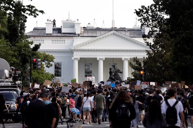 Demonstrators gather to protest the death of George Floyd, Tuesday, June 2, 2020, near the White House in Washington. Floyd died after being restrained by Minneapolis police officers. Moving among the pulsing mass of angry activism outside the White House, a handful of people are on hand to provide help and first aid to both police and protesters alike. THE CANADIAN PRESS/AP-Jacquelyn Martin