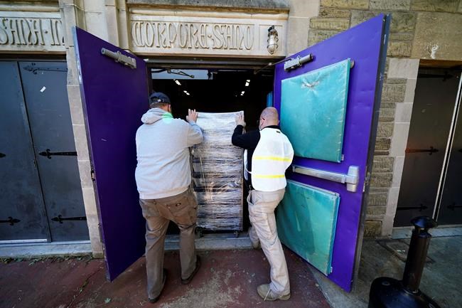 Chester County, Pa., workers transport mail-in and absentee ballots to be processed at West Chester University, Wednesday, Nov. 4, 2020, in West Chester. (AP Photo/Matt Slocum)