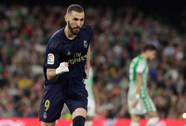 Real Madrid's Karim Benzema celebrates scoring his side's first goal during La Liga soccer match between Betis and Real Madrid at the Benito Villamarin stadium in Seville, Spain, Sunday, March. 8, 2020. (AP Photo/Miguel Morenatti)