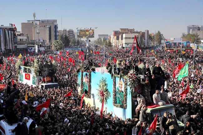 Coffins of Gen. Qassem Soleimani and others who were killed in Iraq by a U.S. drone strike, are carried on a truck surrounded by mourners during a funeral procession, in the city of Kerman, Iran, Tuesday, Jan. 7, 2020. The leader of Iran's Revolutionary Guard threatened on Tuesday to