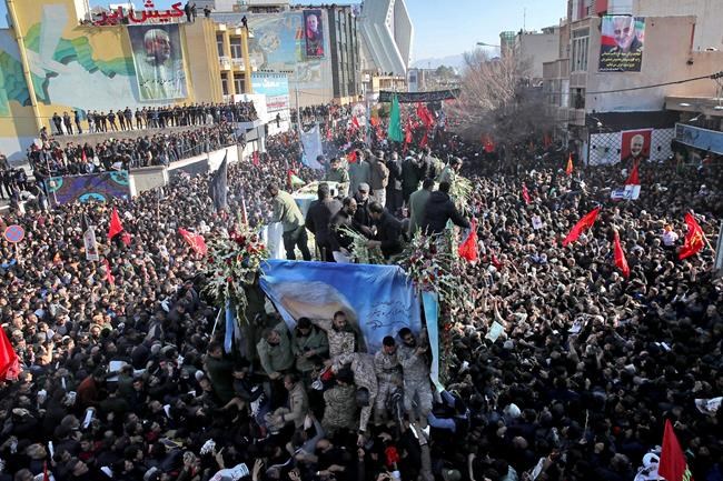 Coffins of Gen. Qassem Soleimani and others who were killed in Iraq by a U.S. drone strike, are carried on a truck surrounded by mourners during a funeral procession, in the city of Kerman, Iran, Tuesday, Jan. 7, 2020. The leader of Iran's Revolutionary Guard threatened on Tuesday to