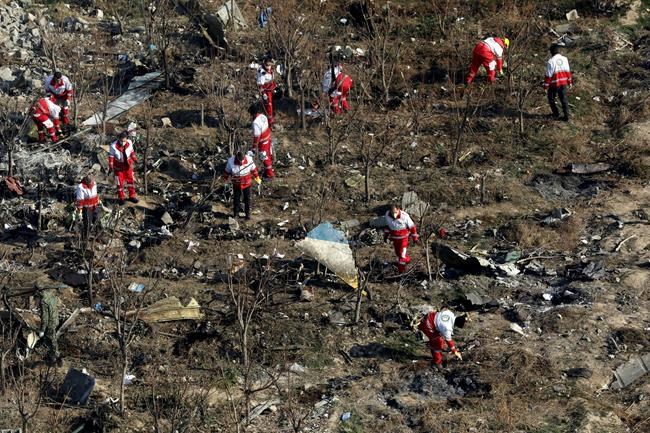 In this Wednesday, Jan. 8, 2020, photo, rescue workers search the scene where a Ukrainian plane crashed in Shahedshahr, southwest of the capital Tehran, Iran. Iran on Saturday, Jan. 11, acknowledged that its armed forces