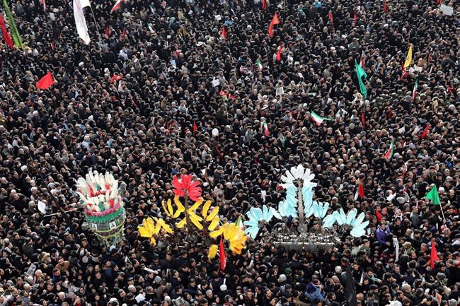 Mourners attend a funeral ceremony for Iranian Gen. Qassem Soleimani and his comrades, who were killed in Iraq in a U.S. drone strike on Friday, at the Enqelab-e-Eslami (Islamic Revolution) square in Tehran, Iran, Monday, Jan. 6, 2020. The processions mark the first time Iran honored a single man with a multi-city ceremony. Not even Ayatollah Ruhollah Khomeini, who founded the Islamic Republic, received such a processional with his death in 1989. Soleimani on Monday will lie in state at Tehran's famed Musalla mosque as the revolutionary leader did before him. (AP Photo/Ebrahim Noroozi)