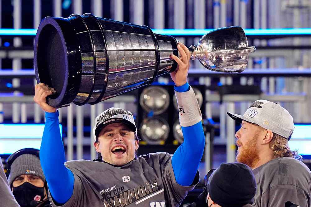 CP
Winnipeg Blue Bombers quarterback Zach Collaros (8) hoists the Grey Cup as he celebrates defeating the Hamilton Tiger-Cats in the 108th CFL Grey Cup in Hamilton, Ont., on Sunday, December 12, 2021. (Frank Gunn / The Canadian Press)