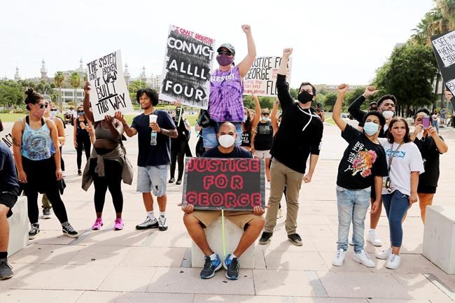 A group of peaceful protesters gather at Curtis Hixon Park to demand justice for victims of police brutality, Sunday, May 31, 2020, in downtown Tampa, Fla. (Douglas R. Clifford/Tampa Bay Times via AP)