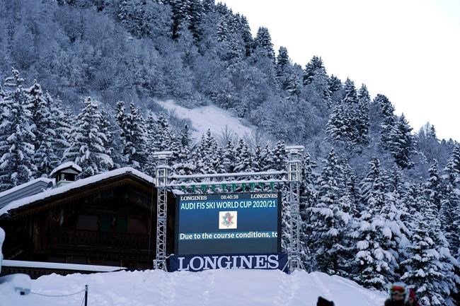 A giant screen reports that an alpine ski, women's World Cup giant slalom was cancelled due to course conditions following strong winds, in Courchevel, France, Saturday, Dec. 13, 2020. (AP Photo/Giovanni Auletta)