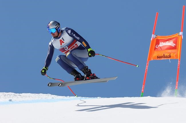 Italy's Dominik Paris speeds down the course during an alpine ski, men's World Cup downhill in Saalbach-Hinterglemm, Austria, Saturday, March 6, 2021. (AP Photo/Alessandro Trovati)