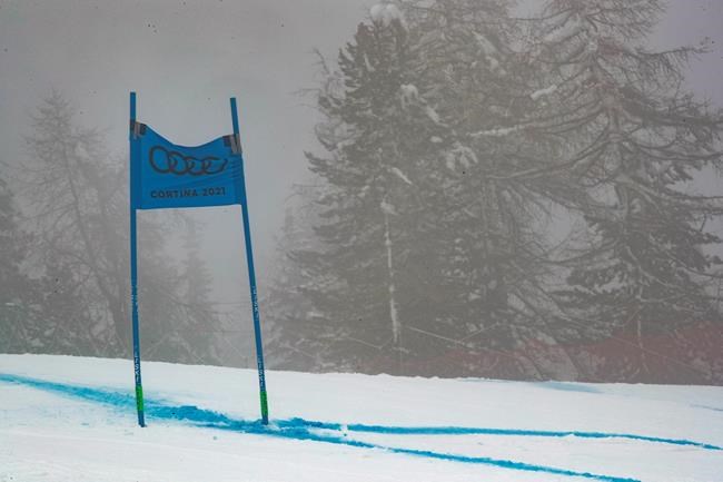 Fog hangs over the course of the women's super-G forcing the delay of the start of the race, at the alpine ski World Championships in Cortina d'Ampezzo, Italy, Tuesday, Feb. 9, 2021. (AP Photo/Gabriele Facciotti)