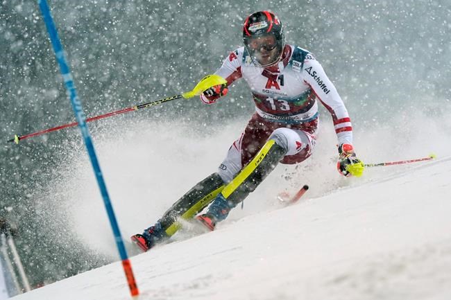 Austria's Michael Matt speeds down the course during an alpine ski, men's World Cup slalom, in Schladming, Austria, Tuesday, Jan. 26, 2021. (AP Photo/Giovanni Auletta)