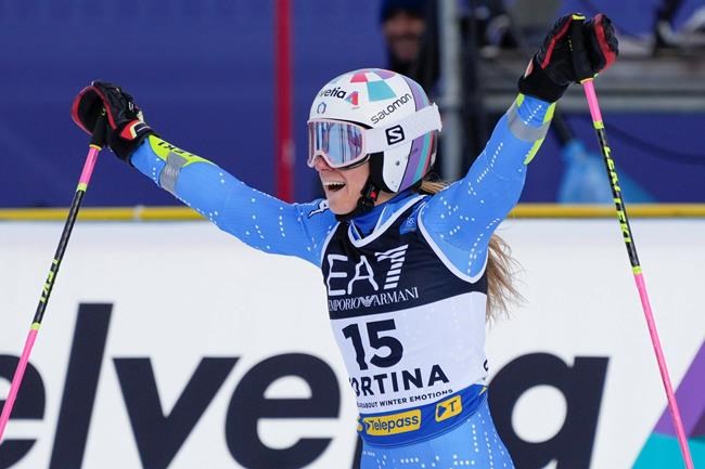 Italy's Marta Bassino celebrates after winning the gold medal of the parallel giant slalom, at the alpine ski World Championships in Cortina d'Ampezzo, Italy, Tuesday, Feb.16, 2021. (AP Photo/Giovanni Auletta)