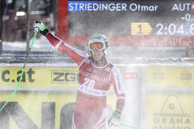 Austria's Otmar Striedinger celebrates as he gets to the finish area after completing an alpine ski, men's World Cup downhill, in Val d'Isere, France, Sunday, Dec. 13, 2020. (AP Photo/Alessandro Trovati)