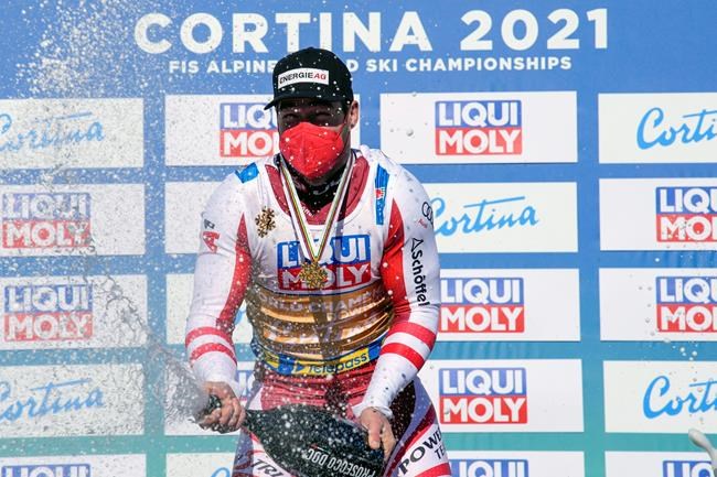 Austria's Vincent Kriechmayr celebrates after winning the men's downhill, at the alpine ski World Championships in Cortina d'Ampezzo, Italy, Sunday, Feb.14, 2021. (AP Photo/Giovanni Auletta)