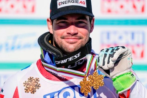 Austria's Vincent Kriechmayr poses with the gold medals of the men's downhill and super-G, at the alpine ski World Championships in Cortina d'Ampezzo, Italy, Sunday, Feb.14, 2021. (AP Photo/Giovanni Auletta)