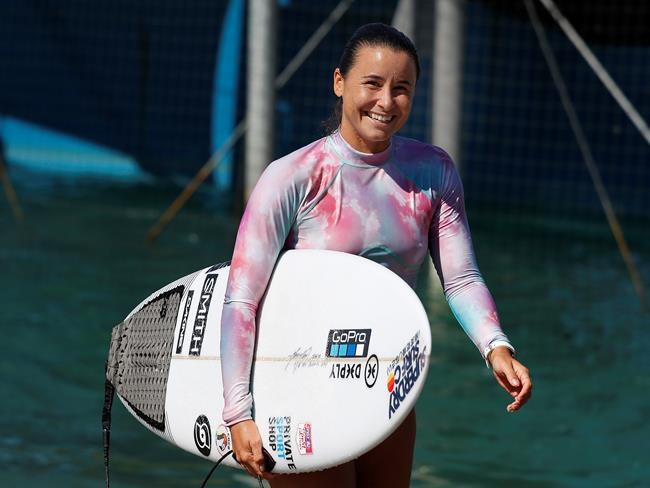 Surfer Johanne Defay, of France, leaves the water after a workout at Surf Ranch during practice rounds for the upcoming Olympics Tuesday, June 15, 2021, in Lemoore, Calif. Defay is headed to the Olympics for surfing's debut at the Games, buoyed by an upset win against reigning world champion Carissa Moore, 28, at the high-intensity Surf Ranch competition last month. Though there's much excitement and renewed enthusiasm for the women's game, the objectification, pay disparities and opportunity gap have taken its toll. Industry leaders say they're committed to righting the wrongs that have long held female surfers back in the male-dominated sport. The mental, financial and logistical roadblocks for women in surfing date back centuries. (AP Photo/Gary Kazanjian)