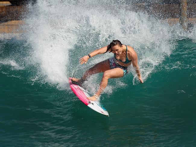 Surfer Carissa Moore of the United States works out on a Surf Ranch wave during practice rounds for the upcoming Olympics Yuesday, June 15, 2021, in Lemoore, Calif. Moore is headed to the Olympics for surfing's debut at the Games, Though there's much excitement and renewed enthusiasm for the women's game, the objectification, pay disparities and opportunity gap have taken its toll. Industry leaders say they're committed to righting the wrongs that have long held female surfers back in the male-dominated sport. The mental, financial and logistical roadblocks for women in surfing date back centuries. (AP Photo/Gary Kazanjian)