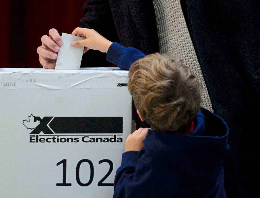 Federal elections in this country still rely on old-fashioned, marked paper ballots, manually inserted into ballot boxes, and then counted and tabulated by hand. (Sean Kilpatrick / Canadian Press files)