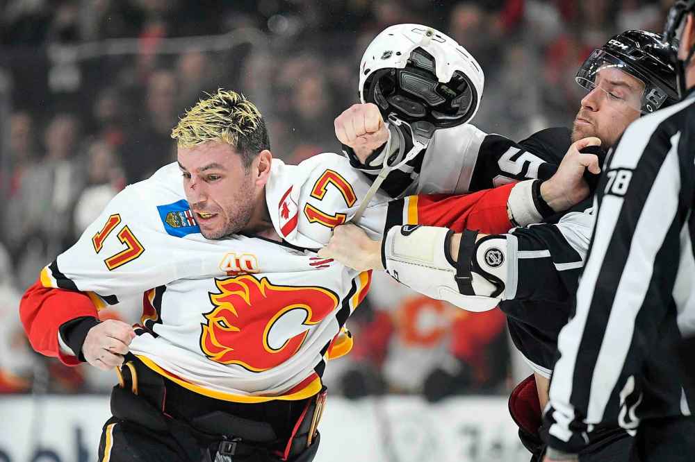 Calgary's Milan Lucic and Los Angeles's Kurtis MacDermid take part in one of the 
projected 222 fights that will occur this season. (Mark J. Terrill / The Associated Press files)