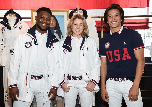 Athletes Daryl Homer (Fencing), left, Jordyn Barratt (Skateboard) and Heimana Reynolds (Skateboard) participate in the Team USA Tokyo Olympic closing ceremony uniform unveiling at the Ralph Lauren SoHo Store on April 13, 2021, in New York. Ralph Lauren is an official outfitter of the 2021 U.S. Olympic Team. (Photo by Evan Agostini/Invision/AP)