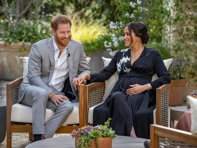 This image provided by Harpo Productions shows Prince Harry, left, and Meghan, Duchess of Sussex, speaking about expecting their second child during an interview with Oprah Winfrey.
