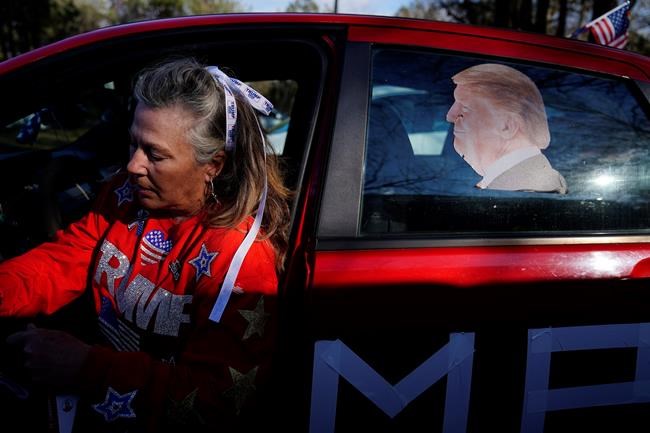 A supporter of President Donald Trump arrives for a campaign rally featuring Trump in support of Senate candidates Sen. Kelly Loeffler, R-Ga., and Sen. David Perdue, R-Ga., in Dalton, Ga., Monday, Jan. 4, 2021. (AP Photo/Brynn Anderson)