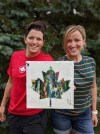 Canadian rugby player Britt Benn, left, presents her sister-in-law Emily Benn with a Maple Leaf painting in Napanee, Ont., July 16, 2020. THE CANADIAN PRESS/HO-, Britt Benn, *MANDATORY CREDIT*