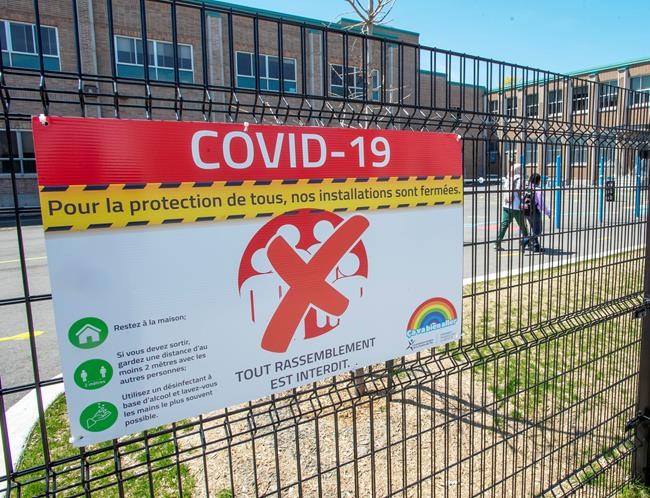 Almost two-third of parents in a new poll say they believe that children returning to school in the fall should wear a mask all, or part of the time. An elementary school in Montreal North is seen, Thursday, May 14, 2020 in Montreal. THE CANADIAN PRESS/Ryan Remiorz