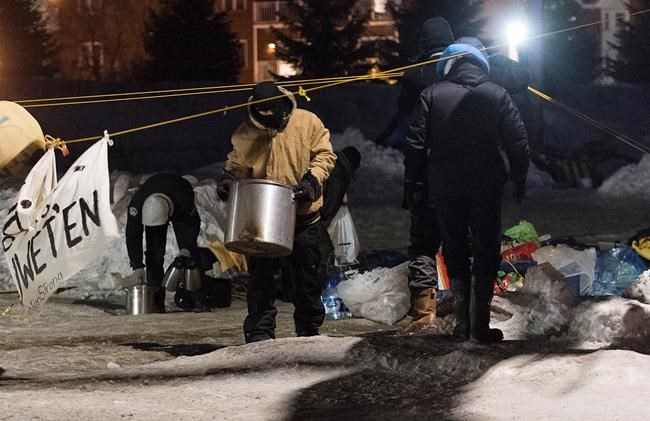 Protesters take belongings from a rail blockade in Saint-Lambert, Que., Friday, February 21, 2020. THE CANADIAN PRESS/Graham Hughes